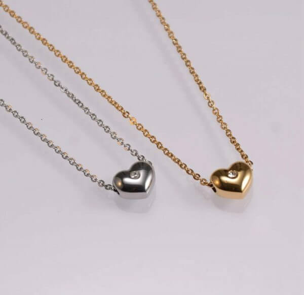 Fashion jewellery heart shape pendant with a shiny white stone