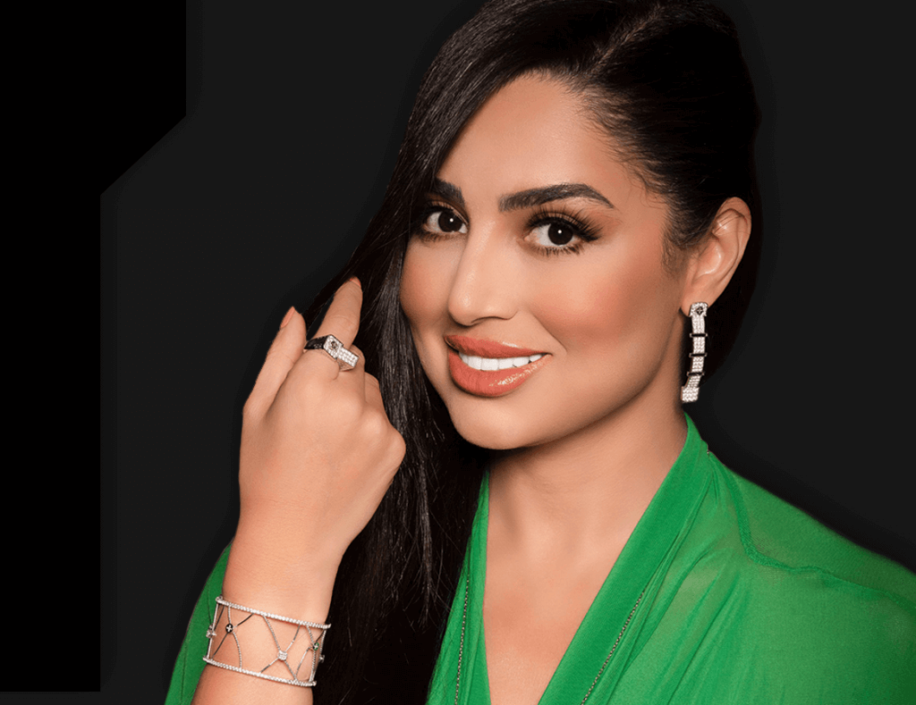 Woman in a green dress wearing Wazna diamond earrings, ring and cuff bracelet